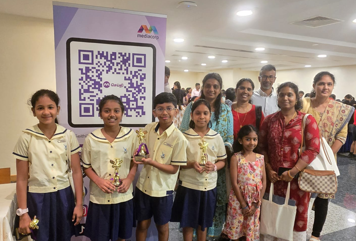 Our semi-finalists with their trophies and their parents pose for a group photo at the competition venue